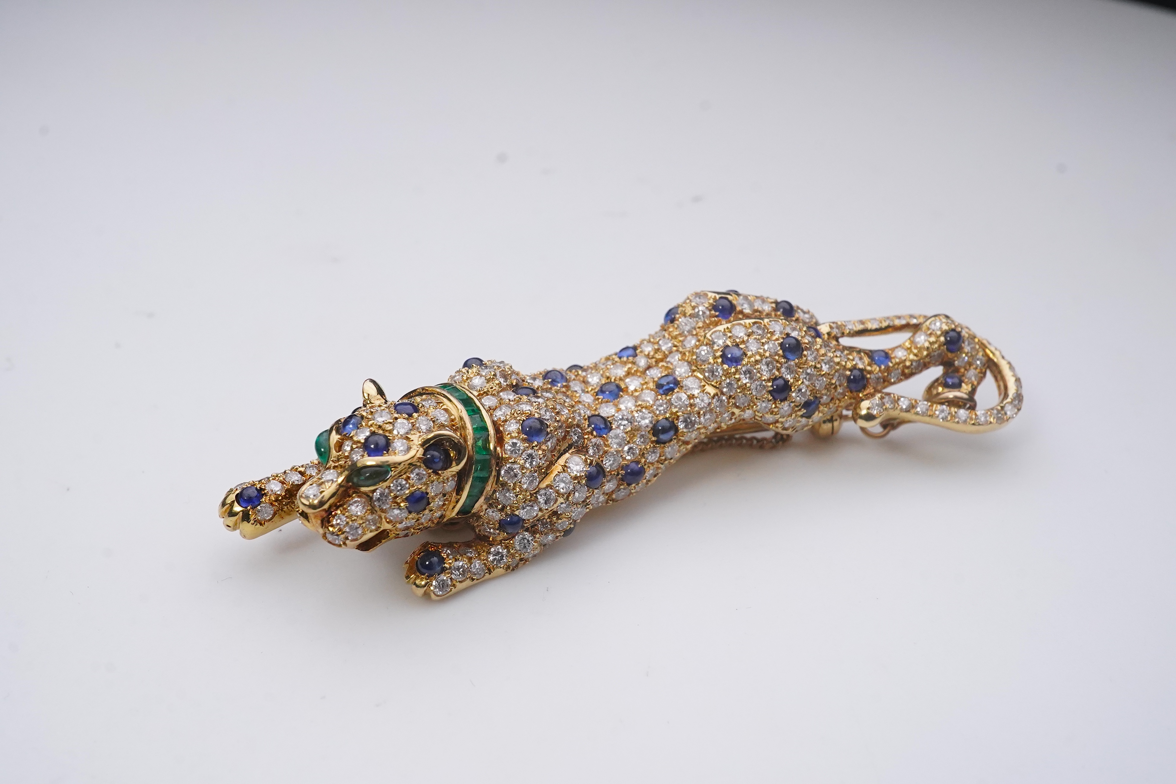 A sapphire, emerald and diamond brooch